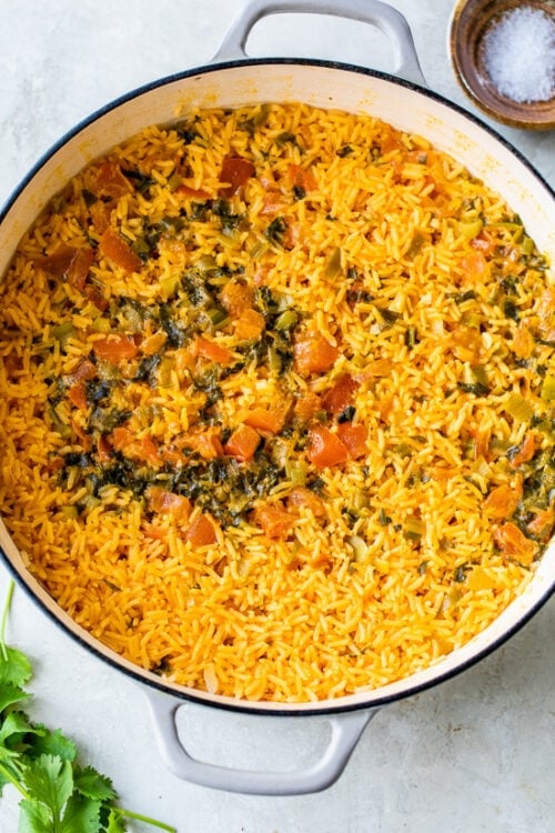 Don't cover the rice until most of the liquid has been absorbed and is just skimming the top.