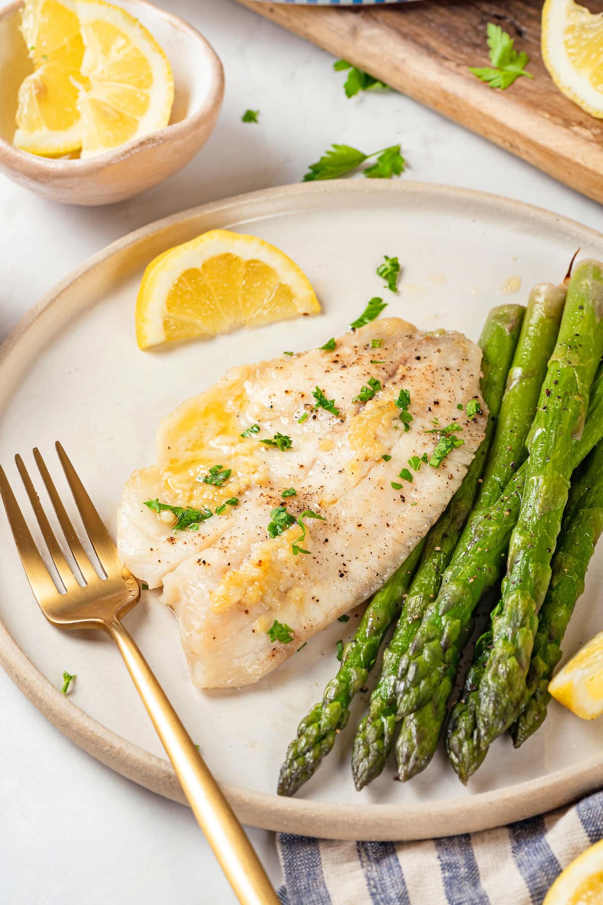 Easy baked tilapia on plate with asparagus