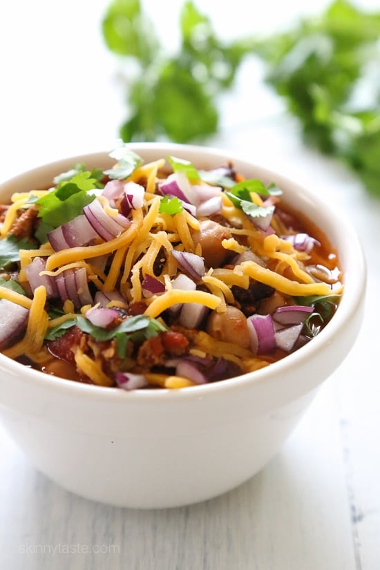 This easy turkey chili recipe uses lean ground turkey and a whole lotta beans! Make this in the slow cooker or Instant Pot, then pile on your favorite chili toppings and enjoy!
