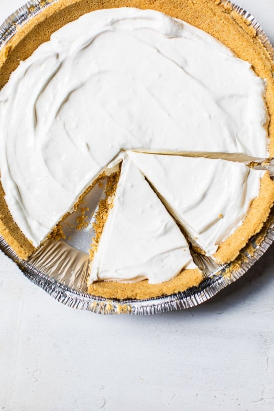 This easy no-bake cheesecake is light, dreamy and so easy to make, you don’t even need an oven. A little slice of heaven! Overhead view of sliced no-bake cheesecake