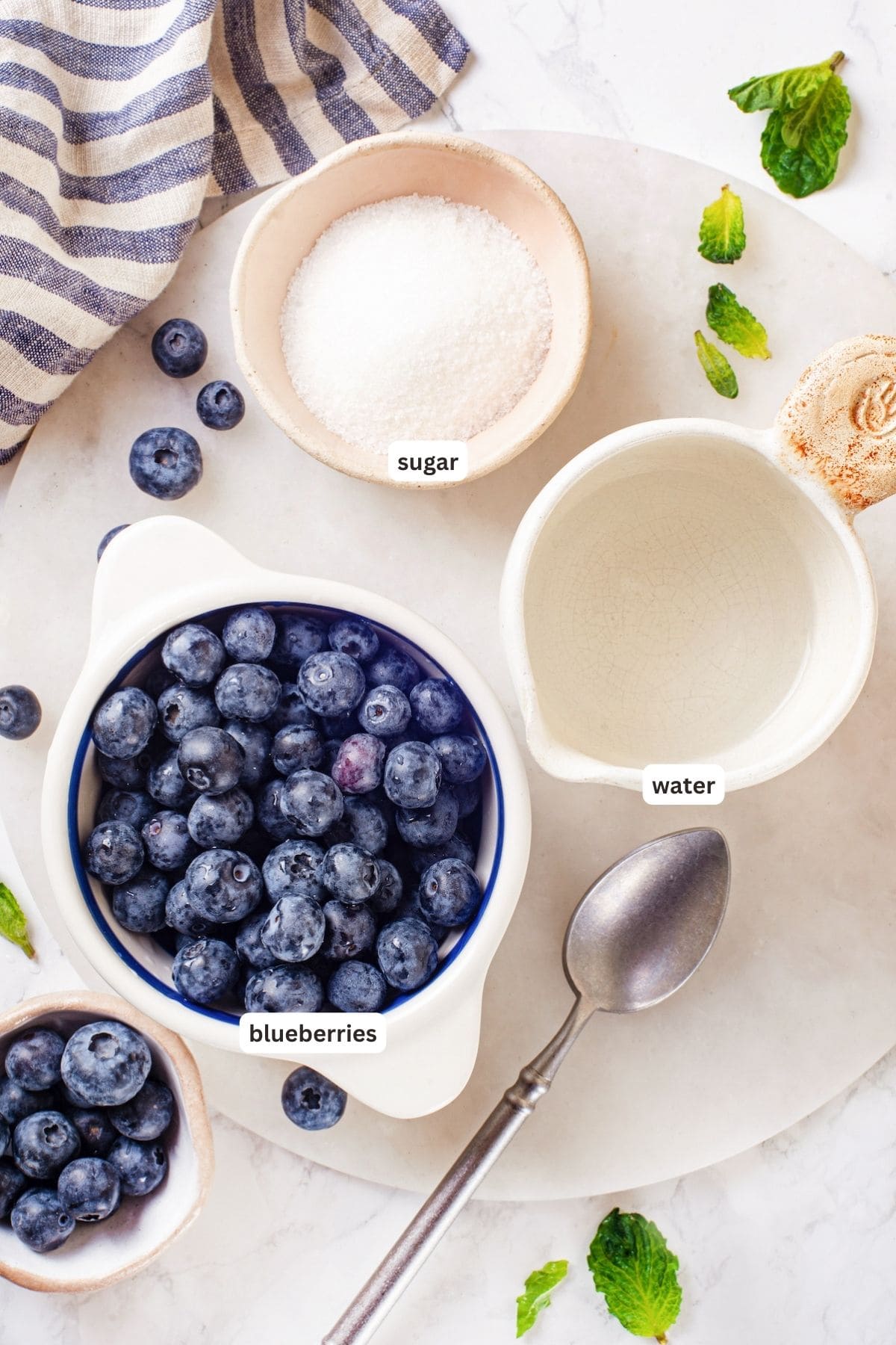 This easy blueberry compote recipe is a 3-ingredient fruit topping perfect for serving over ice cream, yogurt, and more. So summery! Overhead view of ingredients for blueberry compote with labels