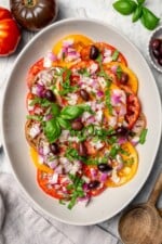 Overhead view of heirloom tomato salad with basil and kalamata olives