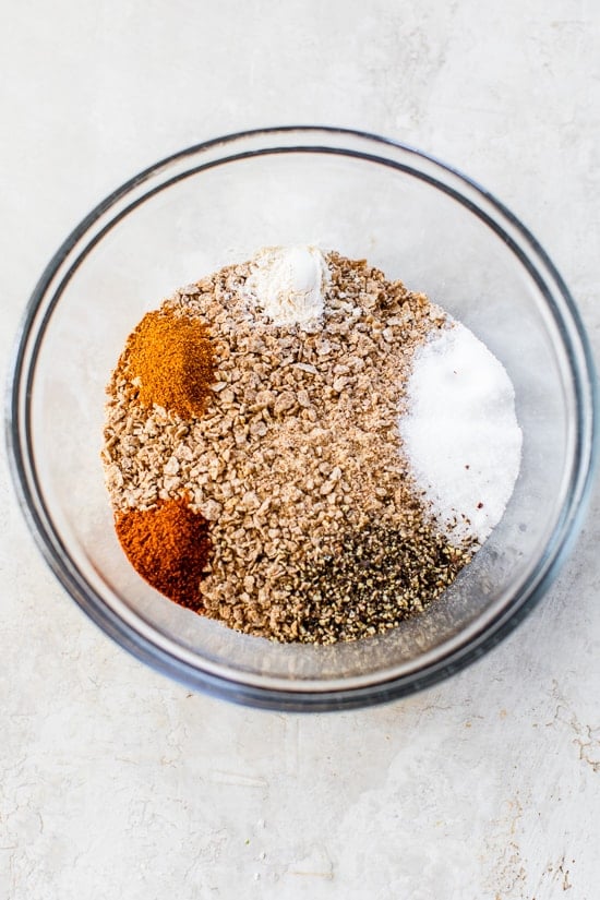 This healthy oven fried chicken is moist on the inside, golden and extra crispy on the outside thanks to a secret ingredient: bran flakes! Ingredients for bran flake chicken coating in glass bowl before stirring.