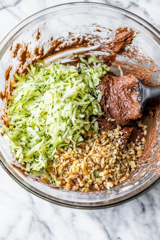 This Chocolate Zucchini Bread is so rich and delicious, no one will guess that it's secretly healthy! Add walnuts for crunch in every bite. Chocolate Zucchini Bread batter in a bowl.