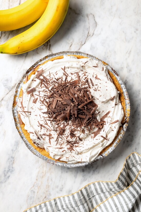 This easy banana cream pie recipe is creamy, fluffy, and full of fresh banana flavor. It’s a lighter take on a classic dessert! Chocolate shavings added to banana cream pie.
