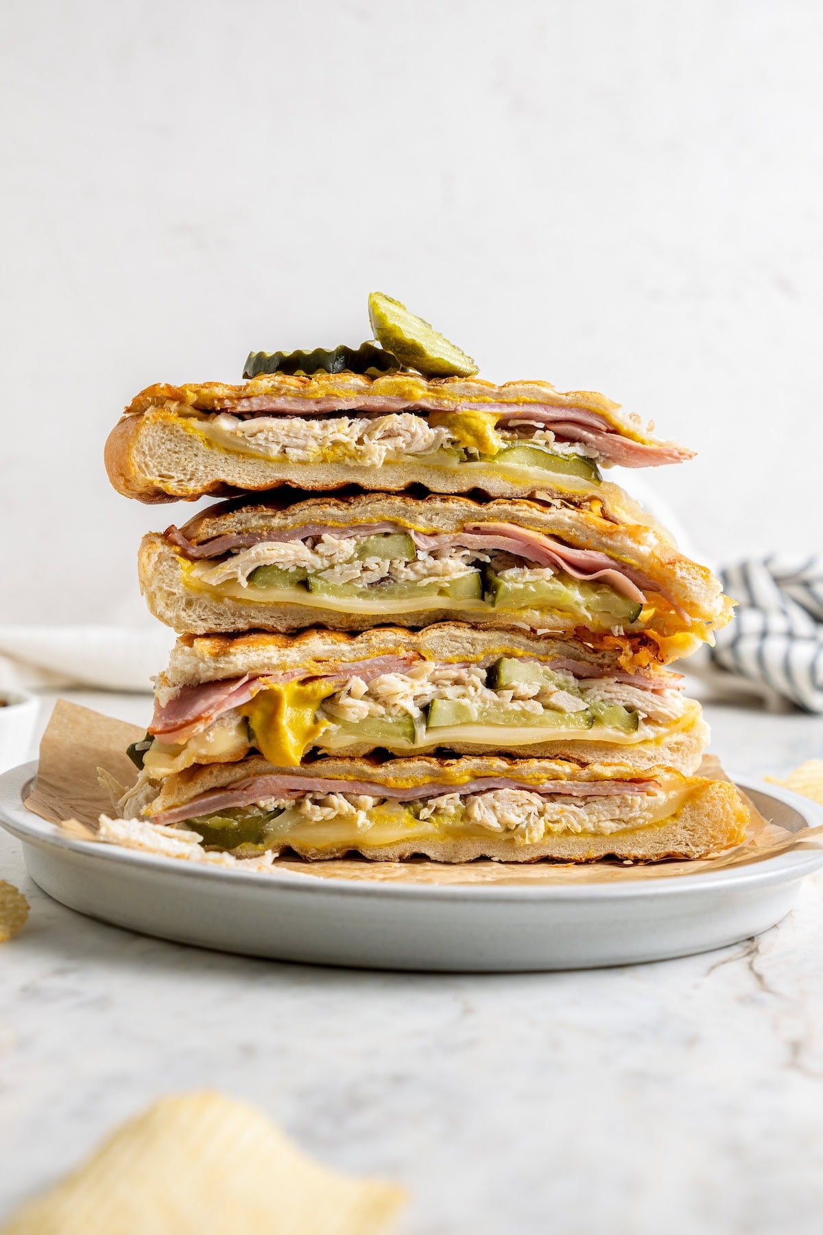 This turkey Cuban sandwich is an easy way to put those Thanksgiving leftovers to use, and my lightened up recipe won’t weigh you down either! Stack of 4 leftover turkey Cuban sandwiches on plate