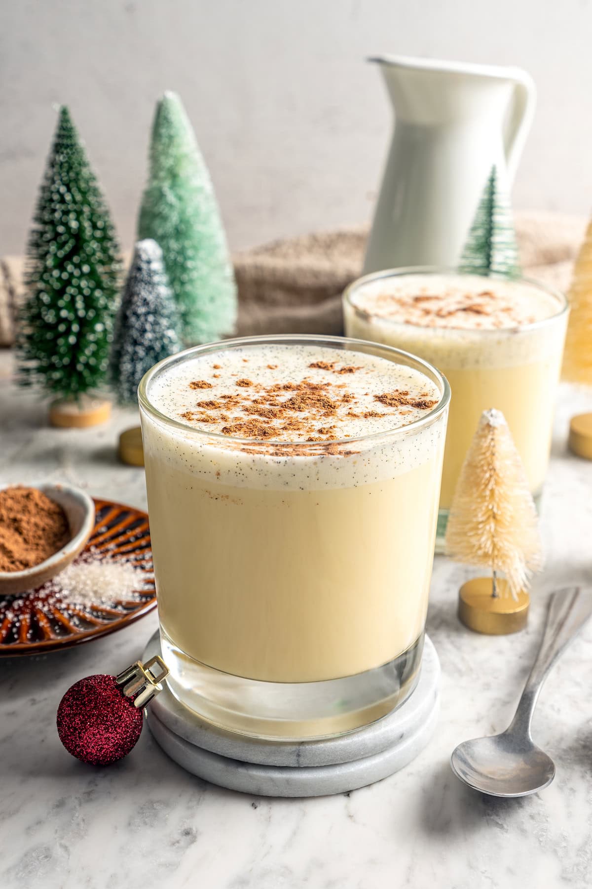 This easy lightened up homemade eggnog recipe comes together quickly and it’s so much tastier than store-bought. Creamy and delicious! Glasses of homemade eggnog