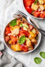 Overhead view of panzanella in bowl with two forks
