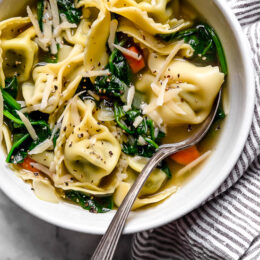Spinach Tortellini en Brodo (in broth) is an Italian soup made with spinach and cheese tortellini and vegetables in a light broth.