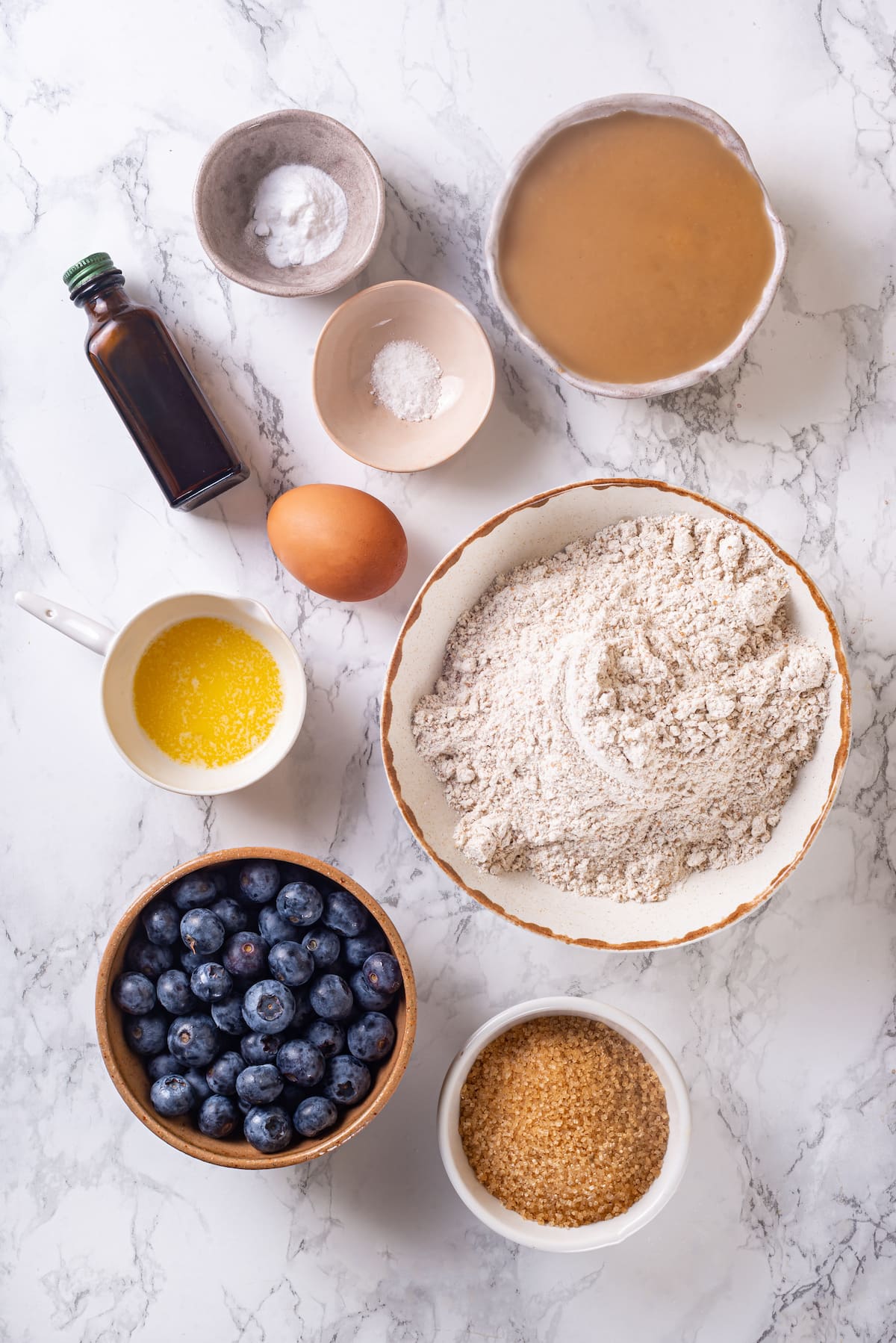 A classic blueberry muffin recipe lightened up with whole wheat flour and applesauce in place of the oil. So moist and delicious! Overhead view of ingredients for blueberry muffin recipe