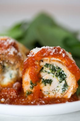 Chicken Rollatini with Spinach alla Parmigiana is Italian comfort food at it's finest! Made with breaded chicken breasts filled and rolled with spinach and cheese topped with sauce and melted mozzarella.