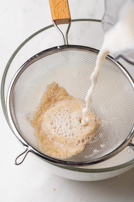 Made with brown rice, milk, sugar, and cinnamon served over ice, this Easy Horchata recipe makes a delightfully refreshing drink for hot days. Blended rice going through a strainer