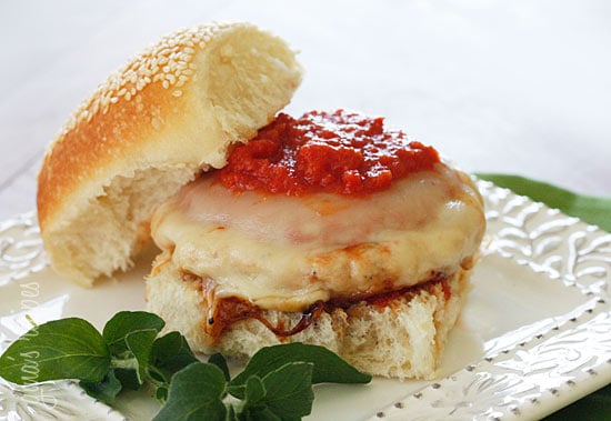 These Chicken Parm Burgers are so easy, the perfect 10 minute recipe for weekday lunch or dinners. All you need is 4 ingredients! A chicken parm burger on a white plate