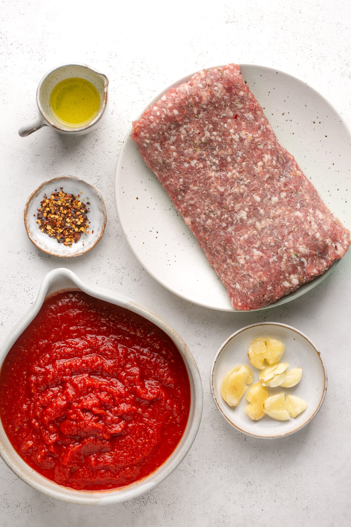 This easy, 5-ingredient sausage pasta sauce is made in the crock pot with flavorful chicken or turkey Italian sausage. Perfect for weeknights! Ingredients needed for Italian sausage pasta sauce.