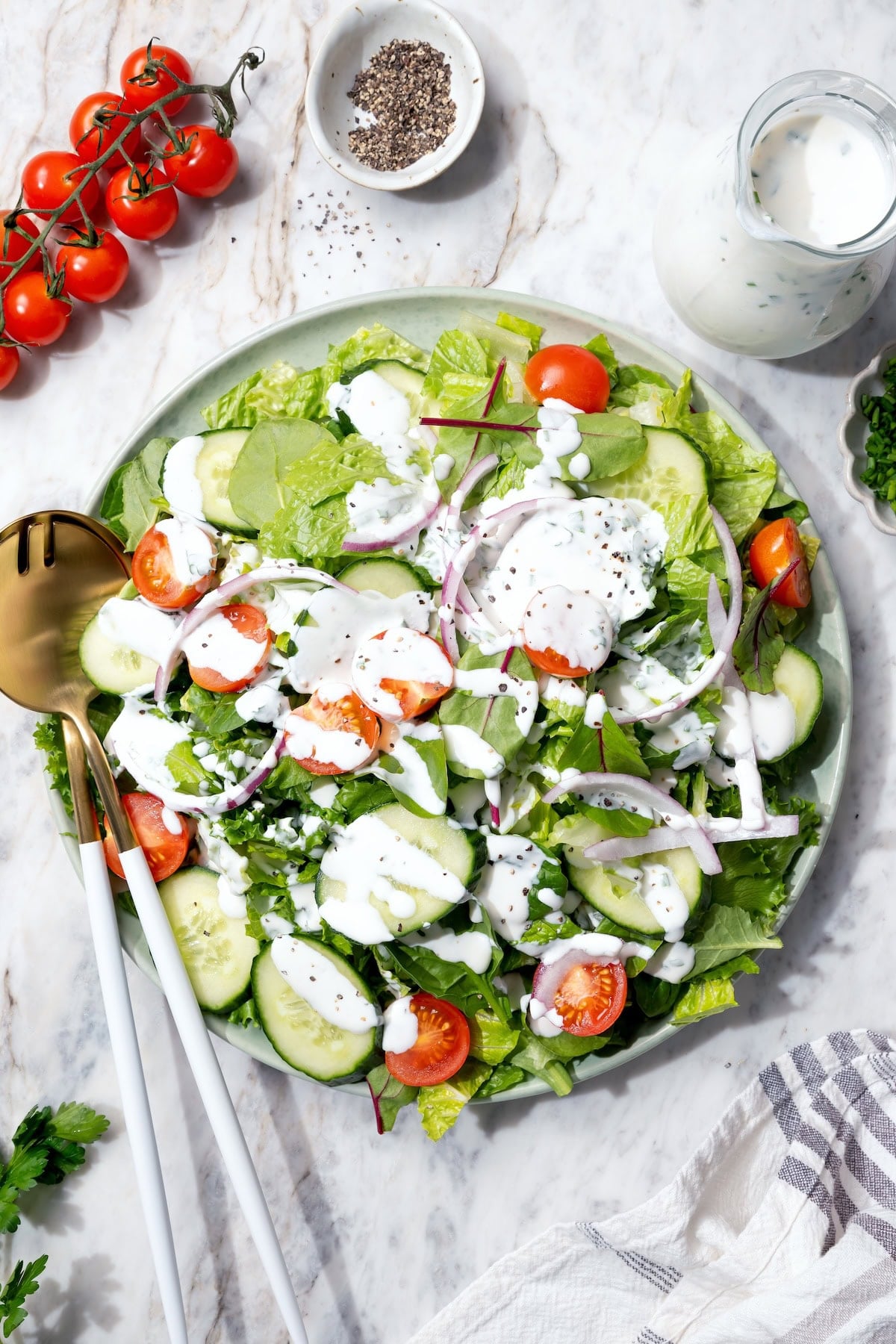 This lightened-up buttermilk ranch dressing is creamy, tangy, and full of fresh herbs. It’s an easy, lighter take on a classic favorite. Buttermilk ranch dressing on garden salad.