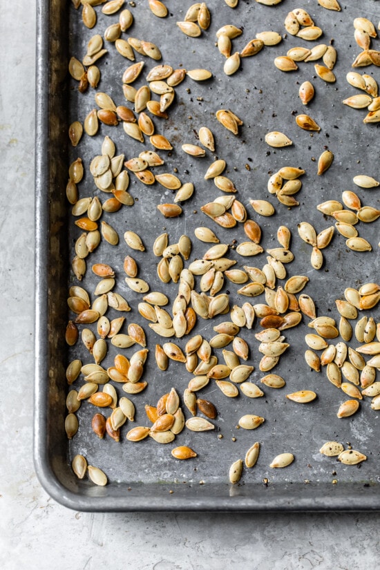 roasted pumpkin seeds on a baking sheet