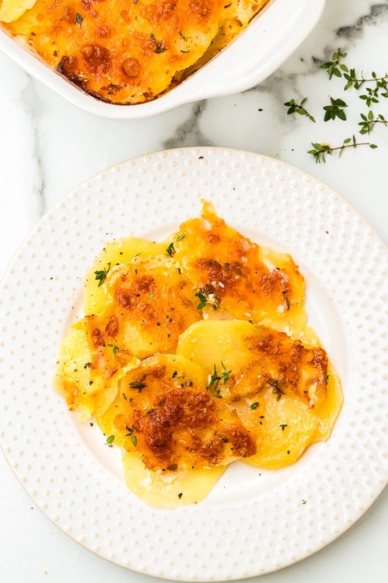 A delicious Scalloped Potato Gratin recipe made with thinly sliced Yukon gold potatoes layered with cheese and a light buttery sauce. Scalloped Potato Gratin