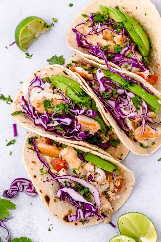 These easy Cilantro Lime Fish Tacos are made with flaky white fish, tomatoes, jalapeños, cilantro and lime topped with avocado.