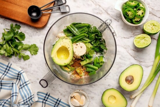 Creamy, bright, and tangy thanks to a buttermilk base, this avocado cilantro lime dressing is perfect for salads, tacos, and dipping veggies. Ingredients for avocado cilantro lime dressing in food processor.