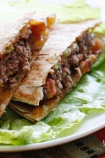 100% grass-fed buffalo burgers with melted cheddar jack cheese and pico de gallo wedged in between two whole wheat tortillas.
