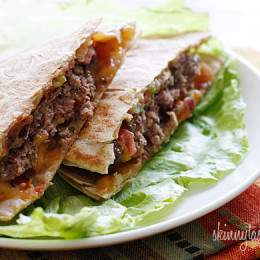 100% grass-fed buffalo burgers with melted cheddar jack cheese and pico de gallo wedged in between two whole wheat tortillas.