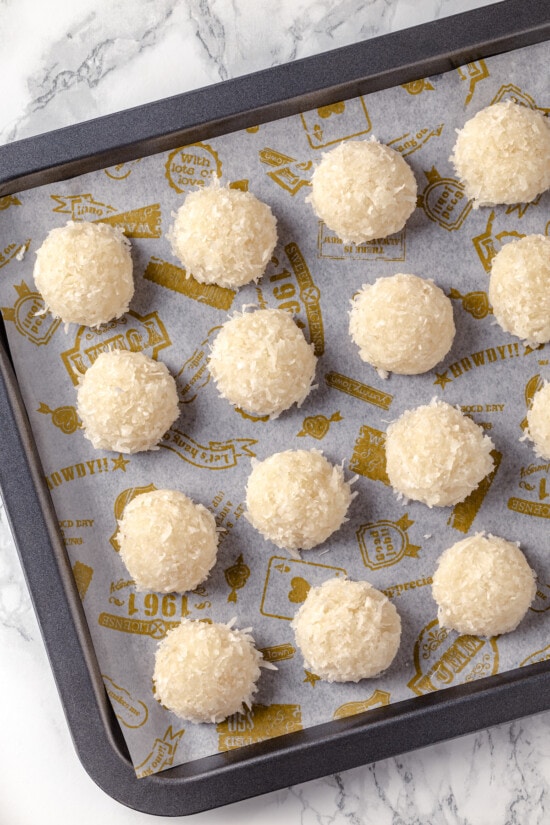 Made with sweetened coconut flakes, egg whites, and just a few other ingredients, Coconut Macaroons are moist, chewy, and perfectly flavored. Unbaked macaroons with coconut on a baking sheet