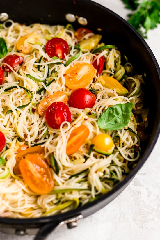 Angel hair pasta tossed with summer zucchini and tomatoes fresh from the garden. The perfect meatless meal you'll be craving again and again. Serve this with plenty of Parmigiano Reggiano!