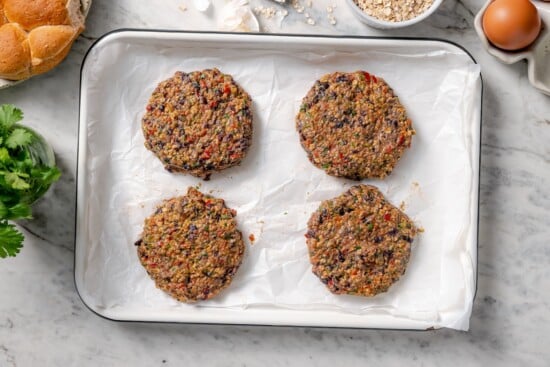 These black bean burgers are flavorful, satisfying and easy to make ahead. With a smoky chipotle mayo and avocado on top, they're delicious! Black bean burgers shaped into patties.