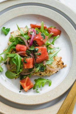 Baked Chicken Milanese is made with breaded chicken cutlets, baked in the oven topped with arugula, tomatoes and balsamic. This is my favorite restaurant dish, made healthier!