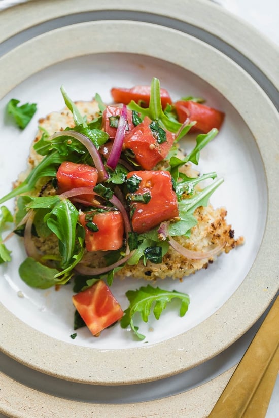 Baked Chicken Milanese is made with breaded chicken cutlets, baked in the oven topped with arugula, tomatoes and balsamic. This is my favorite restaurant dish, made healthier!