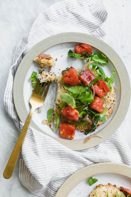 Baked Chicken Milanese is made with breaded chicken cutlets, baked in the oven topped with arugula, tomatoes and balsamic. This is my favorite restaurant dish, made healthier!