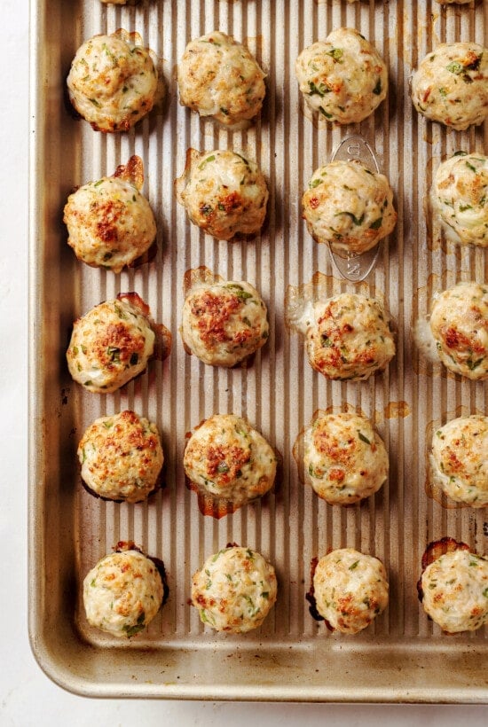Cooked mini turkey meatballs on a baking sheet