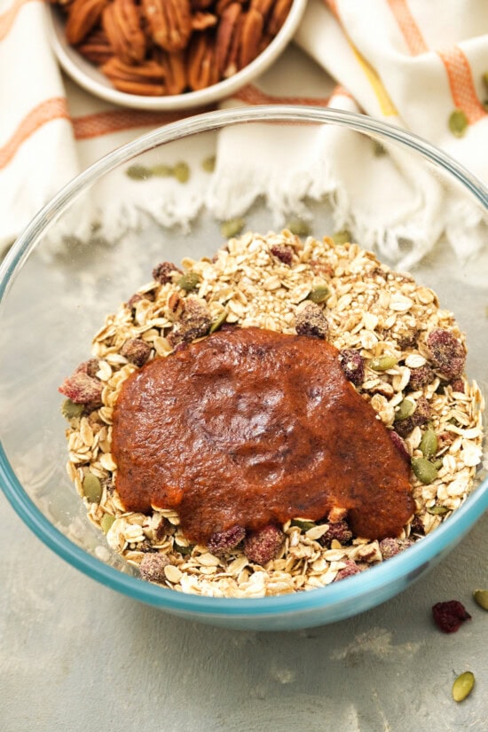 Homemade pumpkin granola with pumpkin, oats, quinoa and flax seed. It's sweetened with maple syrup, has the perfect amount of pumpkin spice! Pumpkin, spices and oats