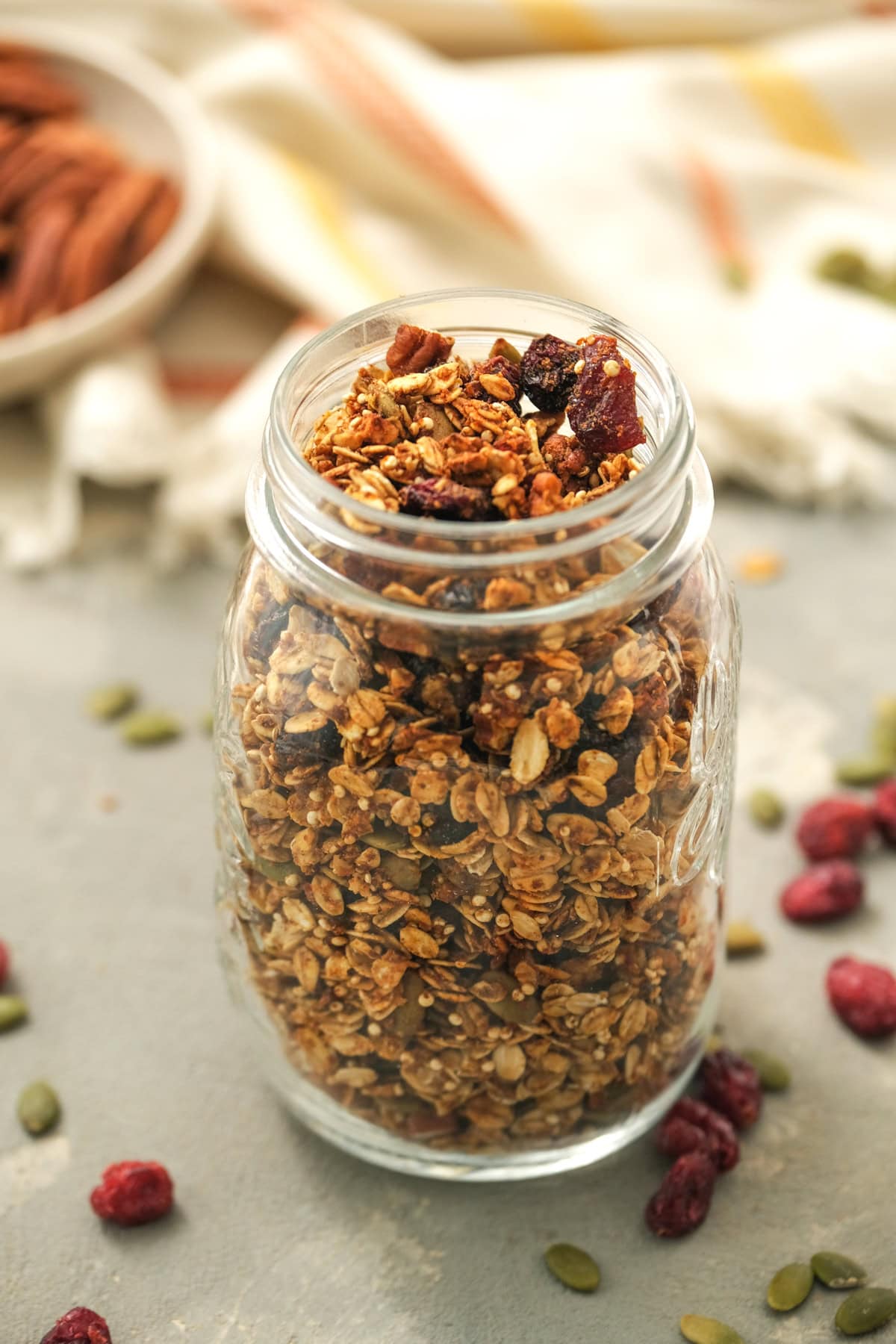 Homemade pumpkin granola with pumpkin, oats, quinoa and flax seed. It's sweetened with maple syrup, has the perfect amount of pumpkin spice! Pumpkin Granola