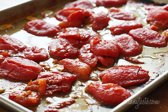 Summer plum tomatoes roasted in the oven with garlic and herbs make an easy, delicious homemade tomato sauce that will fill the room with an intoxicating aroma.