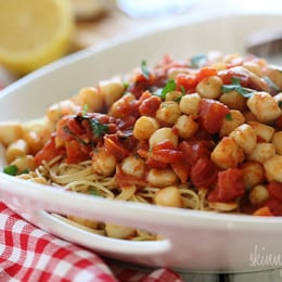 Sauteed bay scallops with tomatoes and a touch of white wine and lemon juice served over angel hair pasta.