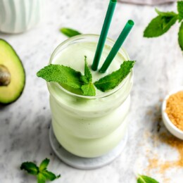 Shamrock shake copycat recipe in glass with sprig of fresh mint