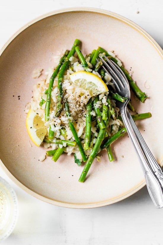 Creamy asparagus risotto, cooked with fresh herbs, Parmigiano-Reggiano and a touch of lemon. Perfect Spring meatless main dish or wonderful topped with grilled shrimp or scallops.