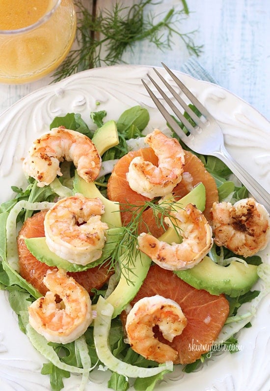 Grilled Shrimp Avocado Fennel and Orange Salad Grilled shrimp, slices of avocado, shaved fennel and oranges are served over baby kale and mixed greens then topped with a citrus vinaigrette.