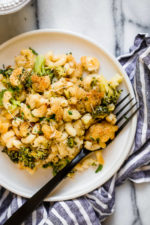 Plate of broccoli mac and cheese with fork.