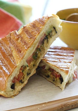 A perfect summer lunch panini made with eggplant, tomatoes, mozzarella and skinny pesto on crispy French bread. Make this for one, or for the whole family.