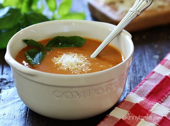 Rich and creamy, this Crockpot Tomato Soup Recipe is the perfect comfort food dish Enjoy with a sandwich or salad for an easy meal. A white bowl of crockpot tomato soup