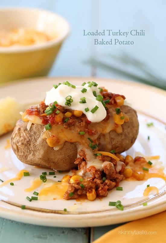 This loaded baked potato is stuffed with lean turkey chili, reduced fat shredded cheese and topped with some fresh chives – a quick, easy weeknight meal.