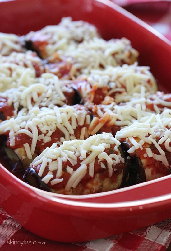 This low-carb eggplant rollatini recipe with creamy ricotta, spinach, savory marinara, and mozzarella is a satisfying vegetarian dinner. Unbaked eggplant rollatini in a baking dish.
