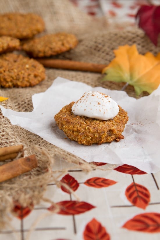 These Pumpkin Spice Quinoa Cookies, made with quinoa and pumpkin spice, are the perfect fall treat. Enjoy them for breakfast or as a snack. A pumpkin quinoa cookie on a piece of parchment paper
