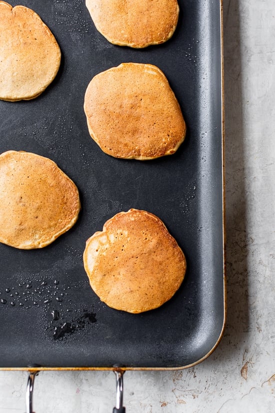 Made with whole wheat flour, pumpkin puree, pumpkin spice, and pecans, these Pumpkin Pancakes are soft, fluffy, and filled with fall flavor. Pumpkin pancakes on a griddle