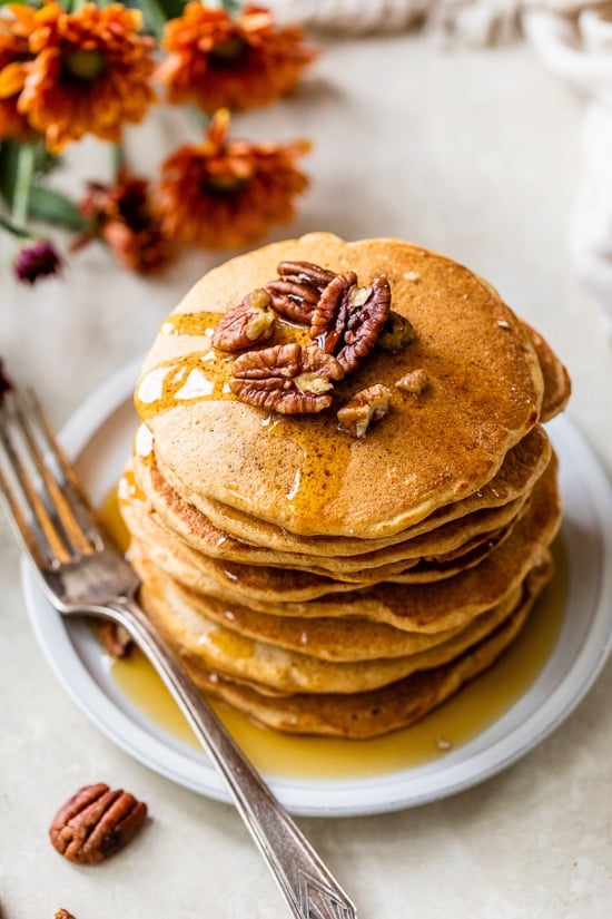 Overhead view of a tall stack of pumpkin pancakes