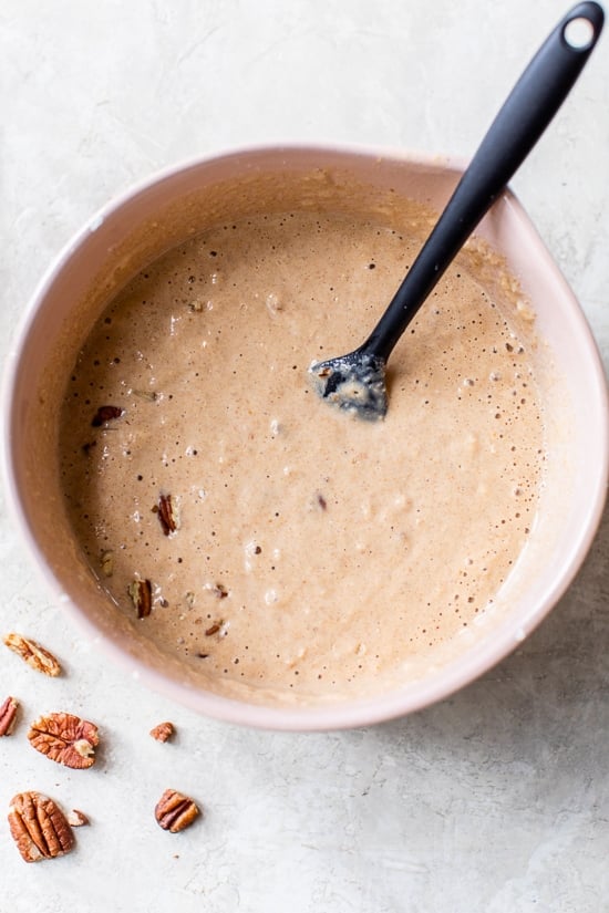 Made with whole wheat flour, pumpkin puree, pumpkin spice, and pecans, these Pumpkin Pancakes are soft, fluffy, and filled with fall flavor. pumpkin pancake batter in a bowl