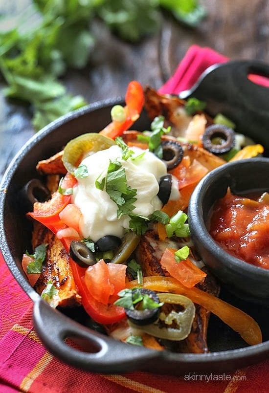 These Irish style baked sweet potato wedges are topped with my favorite nacho toppings and they are dangerously good!!