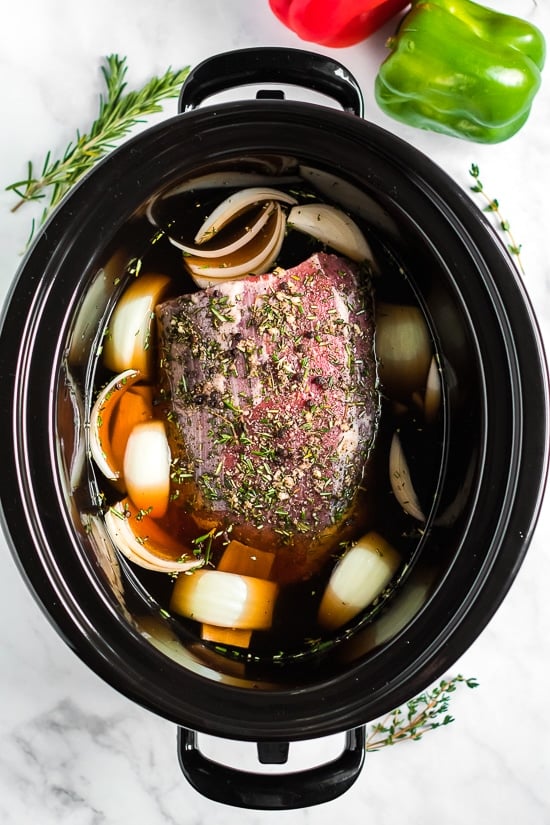 Slow Cooker French Dip Sandwich with Caramelized Onions filled with beef, melted cheese and au jus (beef broth) for dipping–the perfect weekend crock pot recipe! Crock Pot French Dip